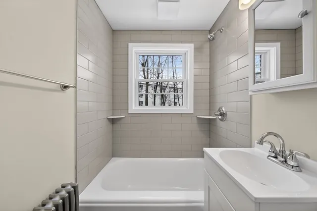 a white bath tub sitting next to a white sink