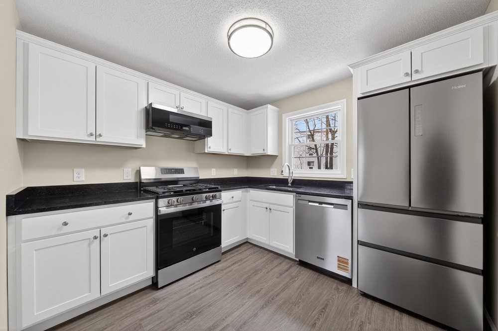 508 Cold Spring Avenue, Unit 1A West Springfield, MA 01089 - Photo 2 of 27 a kitchen with granite countertop a refrigerator stove top oven and sink