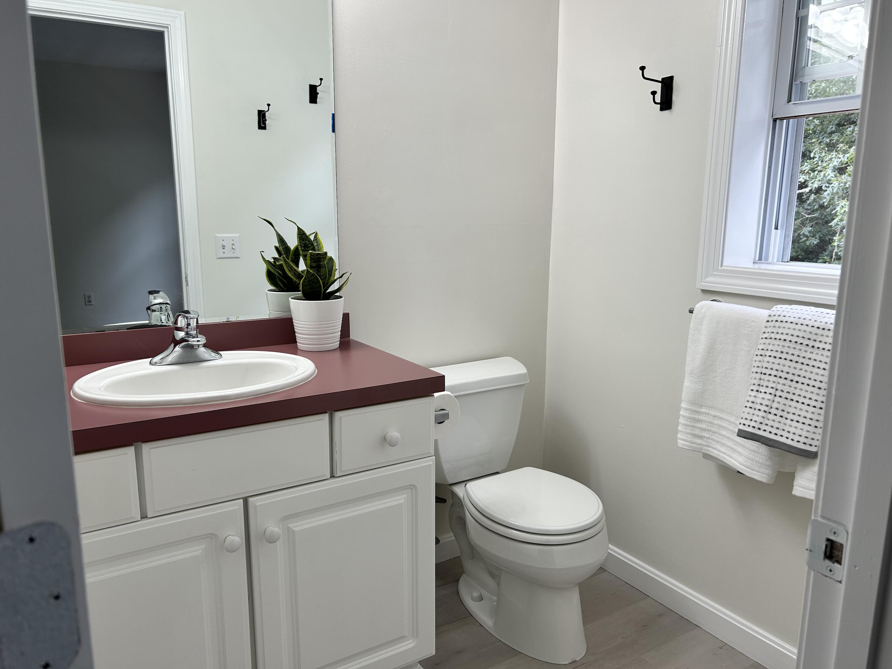 121 Old Post Road Centerville, MA 02632 - Photo 16 of 39 a bathroom with a toilet sink and mirror