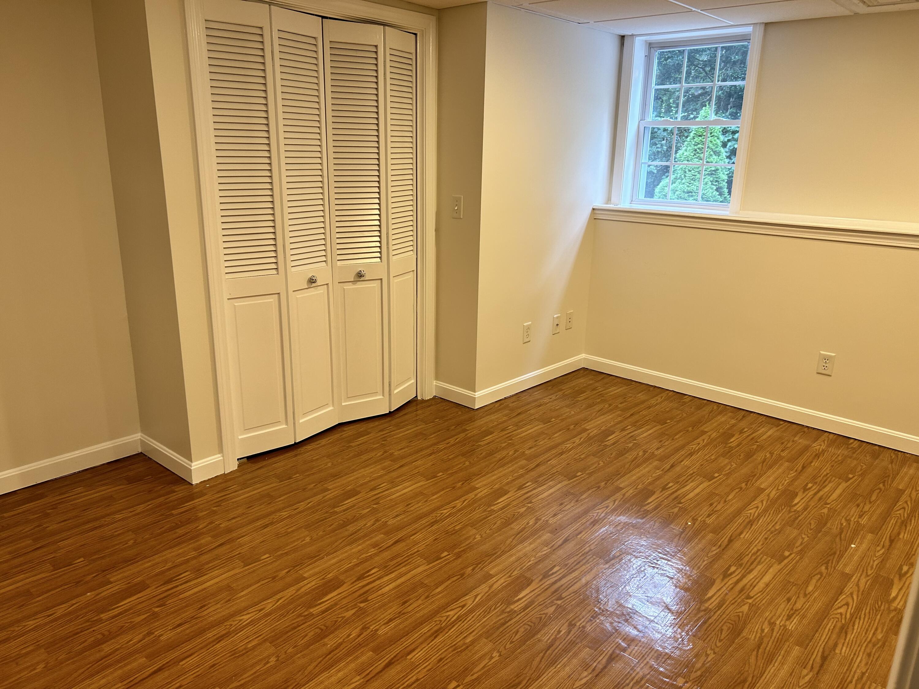 121 Old Post Road Centerville, MA 02632 - Photo 24 of 39 a view of an empty room with wooden floor and a window