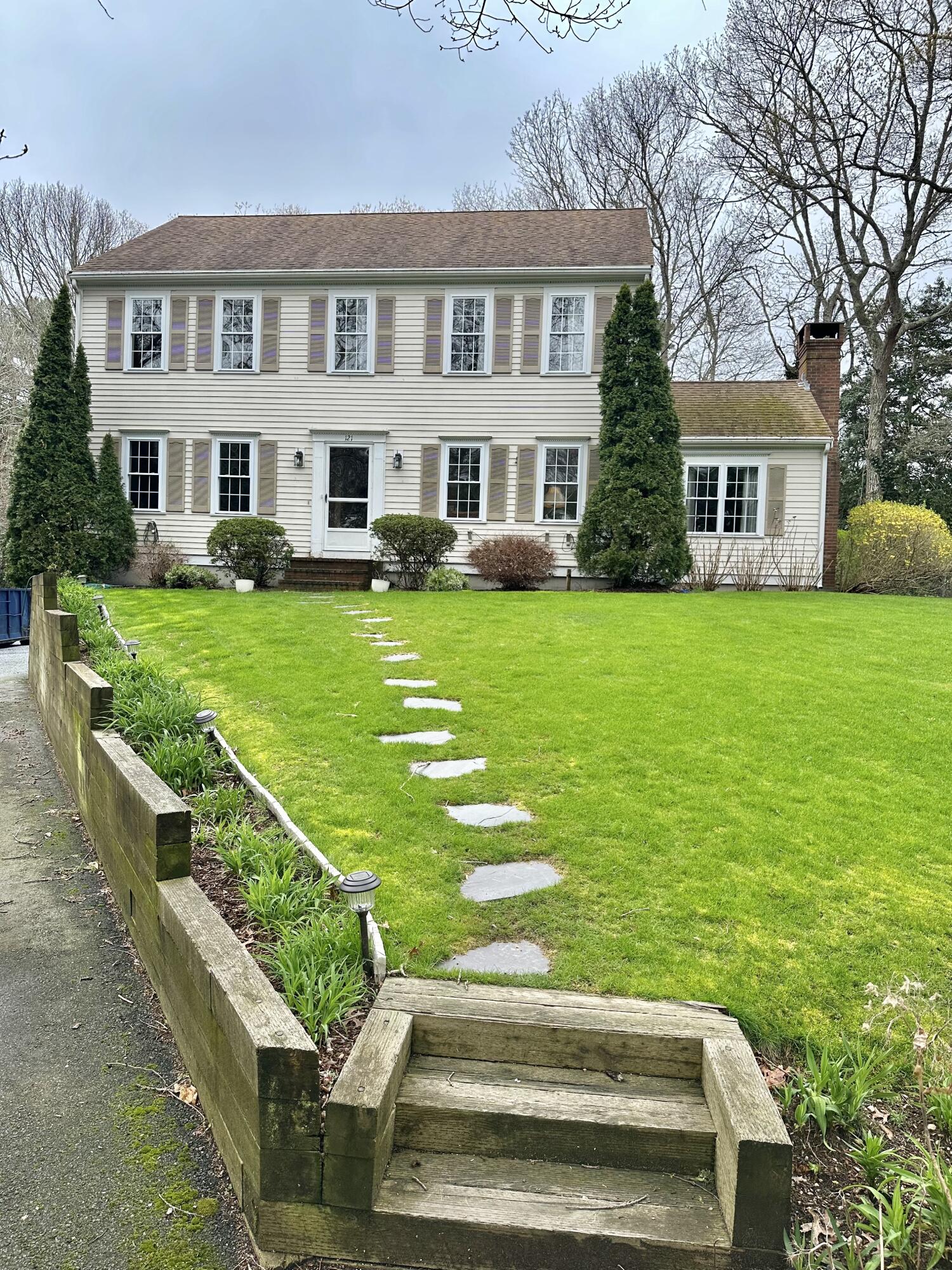 121 Old Post Road Centerville, MA 02632 - Photo 30 of 39 a front view of a house with a yard table and chairs