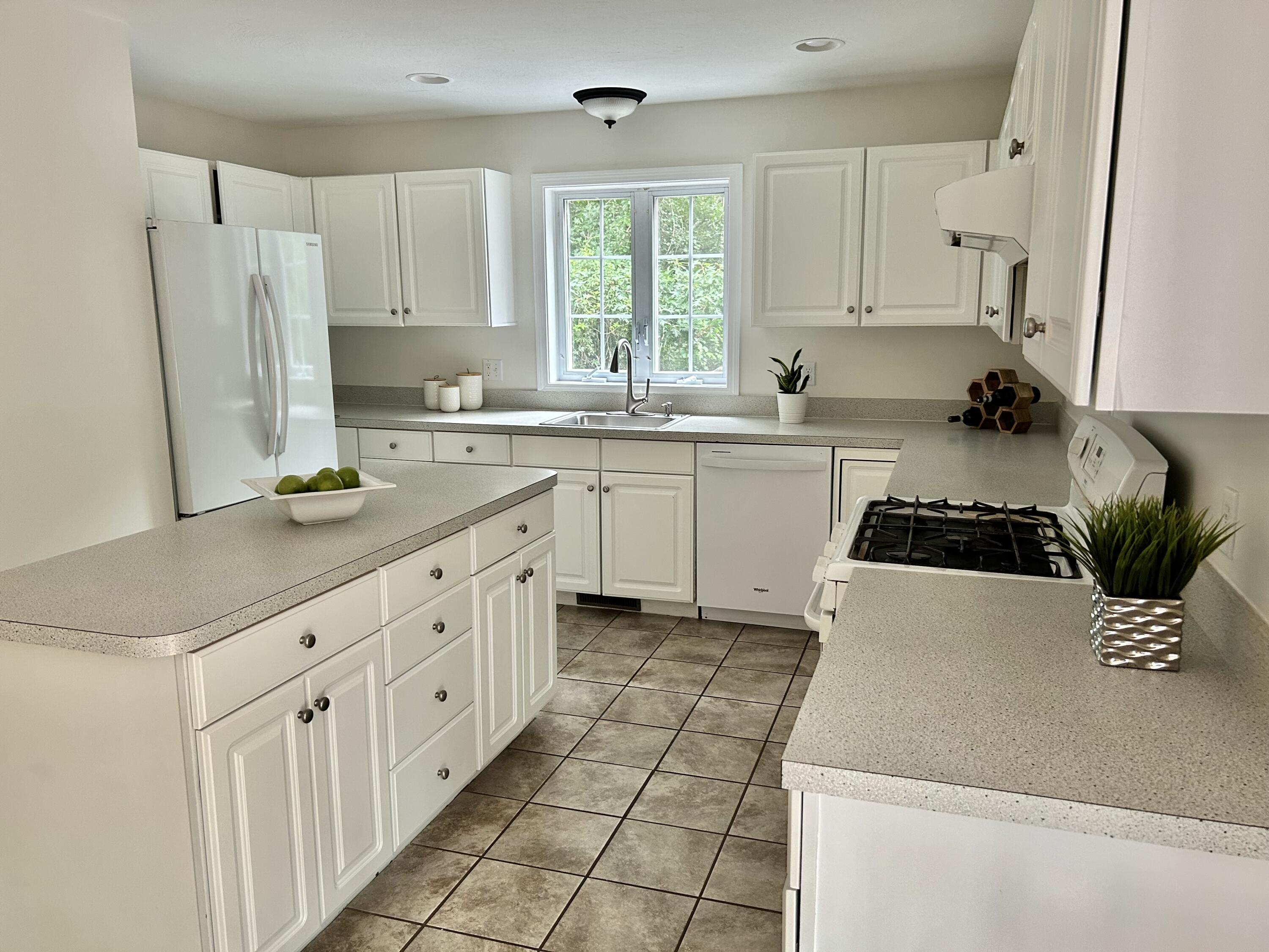 121 Old Post Road Centerville, MA 02632 - Photo 4 of 39 a kitchen with a white cabinets and white appliances