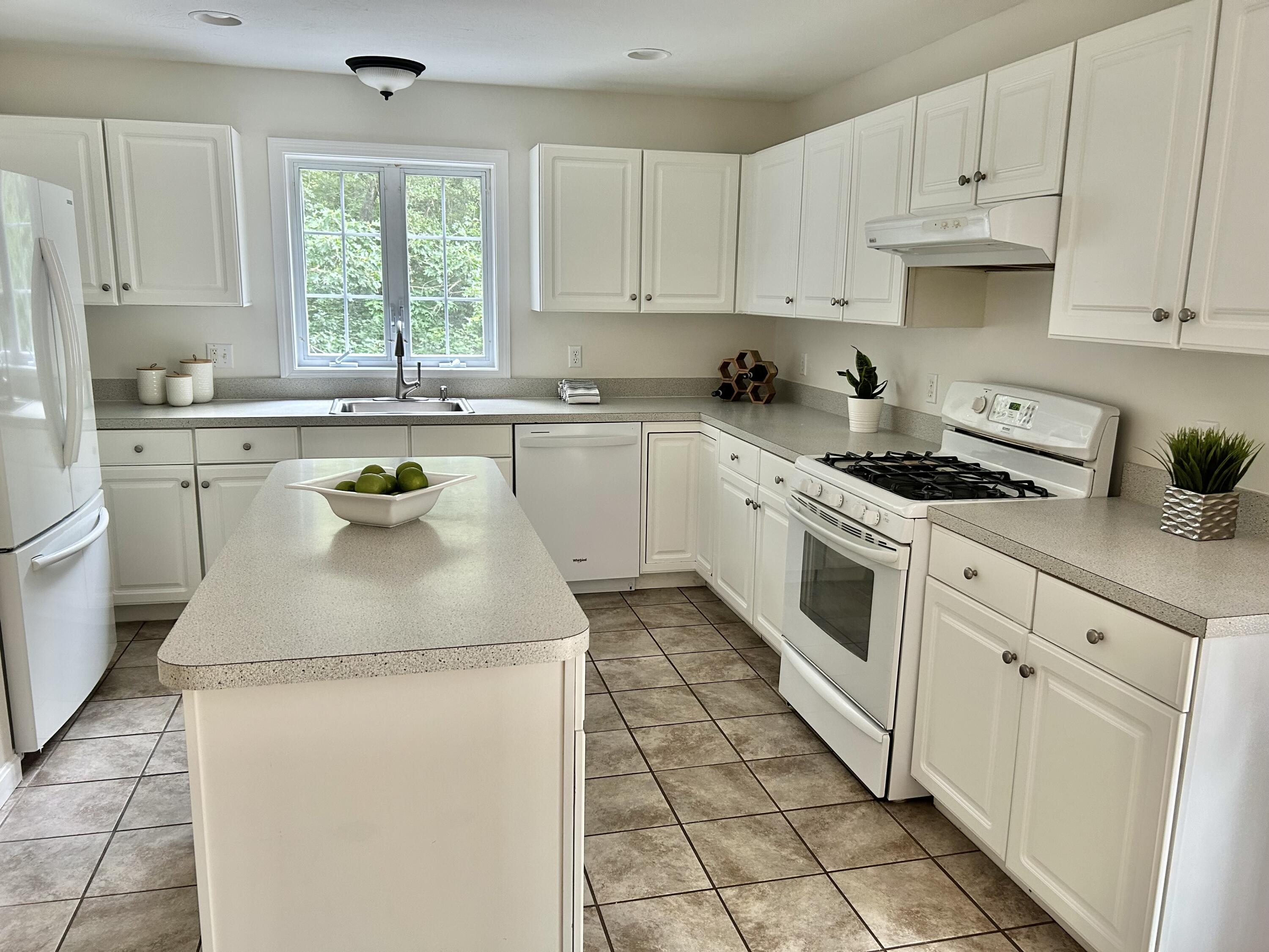 121 Old Post Road Centerville, MA 02632 - Photo 5 of 39 a kitchen with sink cabinets and window