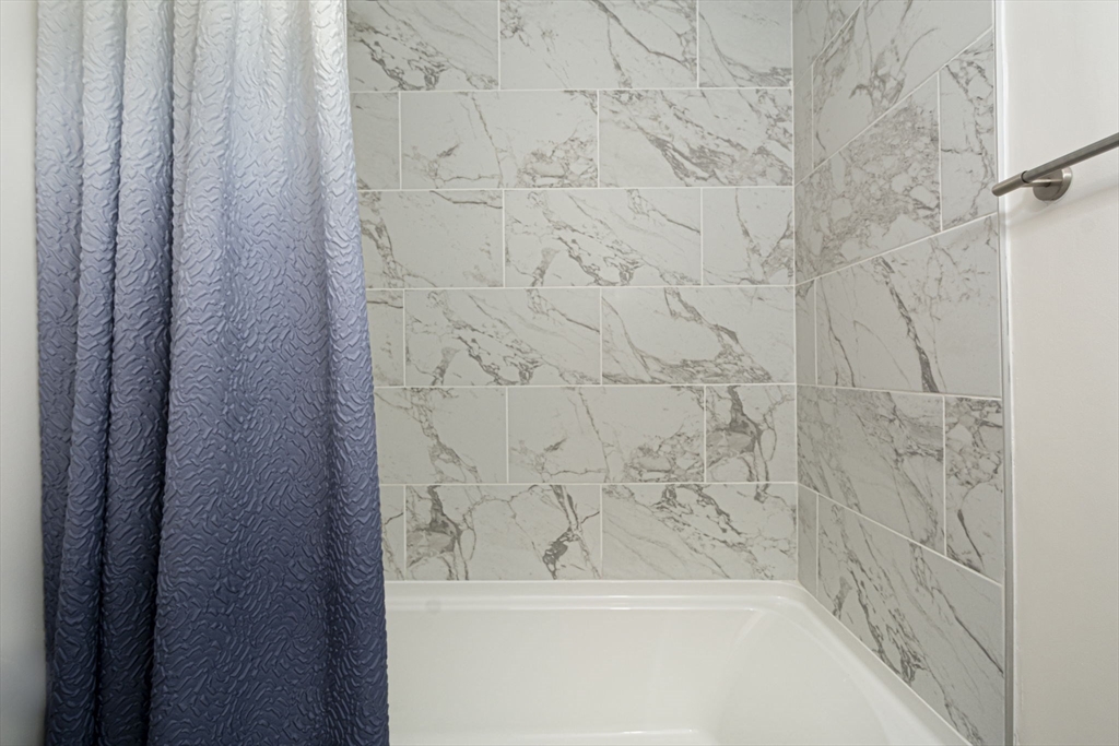 29 Reo Road Maynard, MA 01754 - Photo 20 of 23 a bathroom with a shower