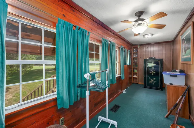 a view of a livingroom with furniture and a large window