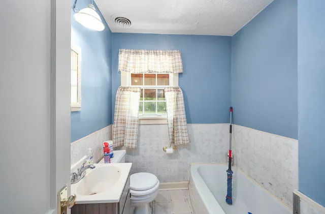 a bathroom with a sink toilet and bathtub