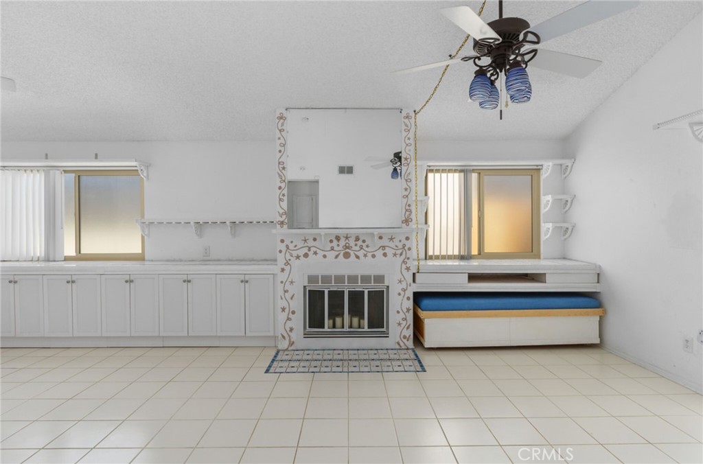 29368 Murrieta Road Menifee, CA 92586 - Photo 6 of 20 a spacious bedroom with a bed and a chandelier