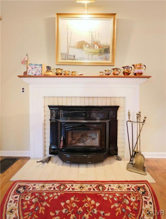 1043 Capp Road Nazareth, PA 18064 - Photo 8 of 41 a living room with a fireplace and a wooden floor