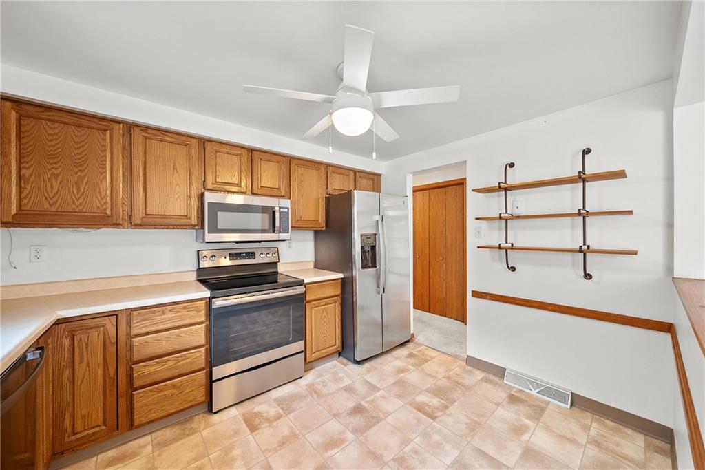 2775 Tischler Road Bethel Park, PA 15102 - Photo 6 of 33 a kitchen with granite countertop a stove a sink and a refrigerator