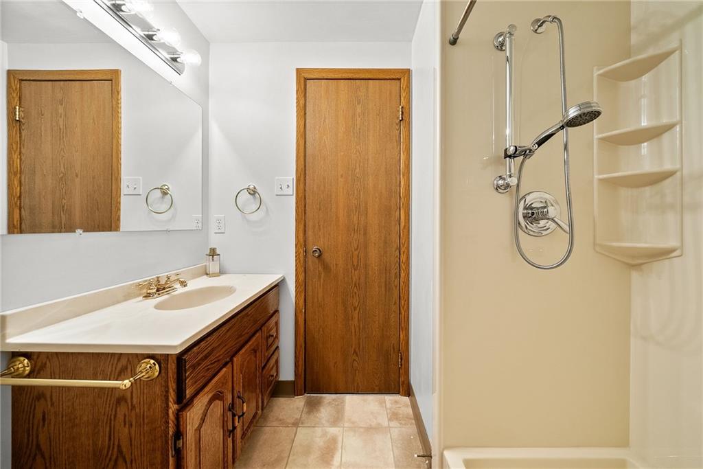 2775 Tischler Road Bethel Park, PA 15102 - Photo 10 of 33 a bathroom with a granite countertop sink a mirror and a shower