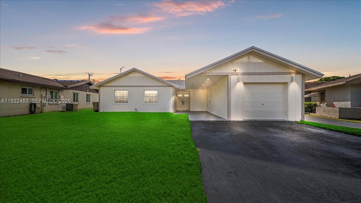 2279 Nova Village Drive Davie, FL 33317 - Photo 1 of 15 a view of a white house next to a yard and a large tree