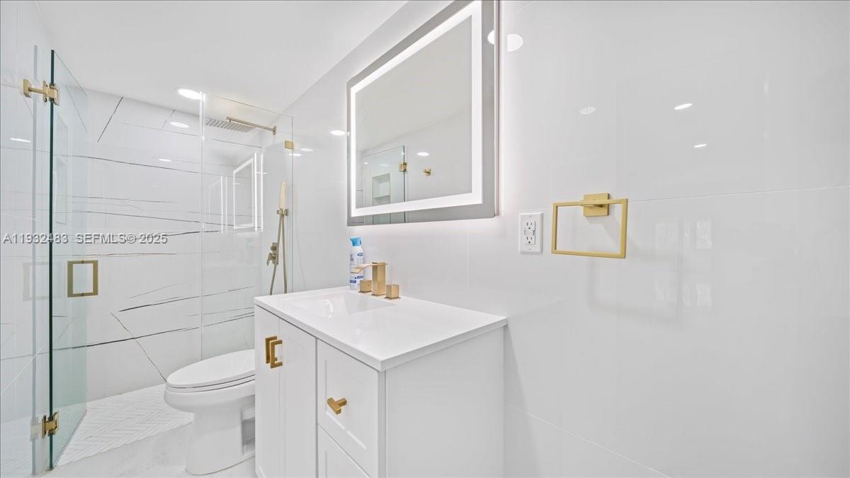 2279 Nova Village Drive Davie, FL 33317 - Photo 11 of 15 a bathroom with a toilet a sink a mirror and vanity