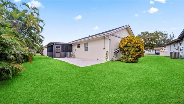 a view of a backyard with plants and a garden