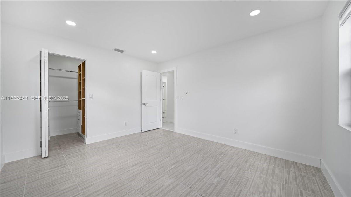 2279 Nova Village Drive Davie, FL 33317 - Photo 10 of 15 a view of an empty room with wooden floor and closet