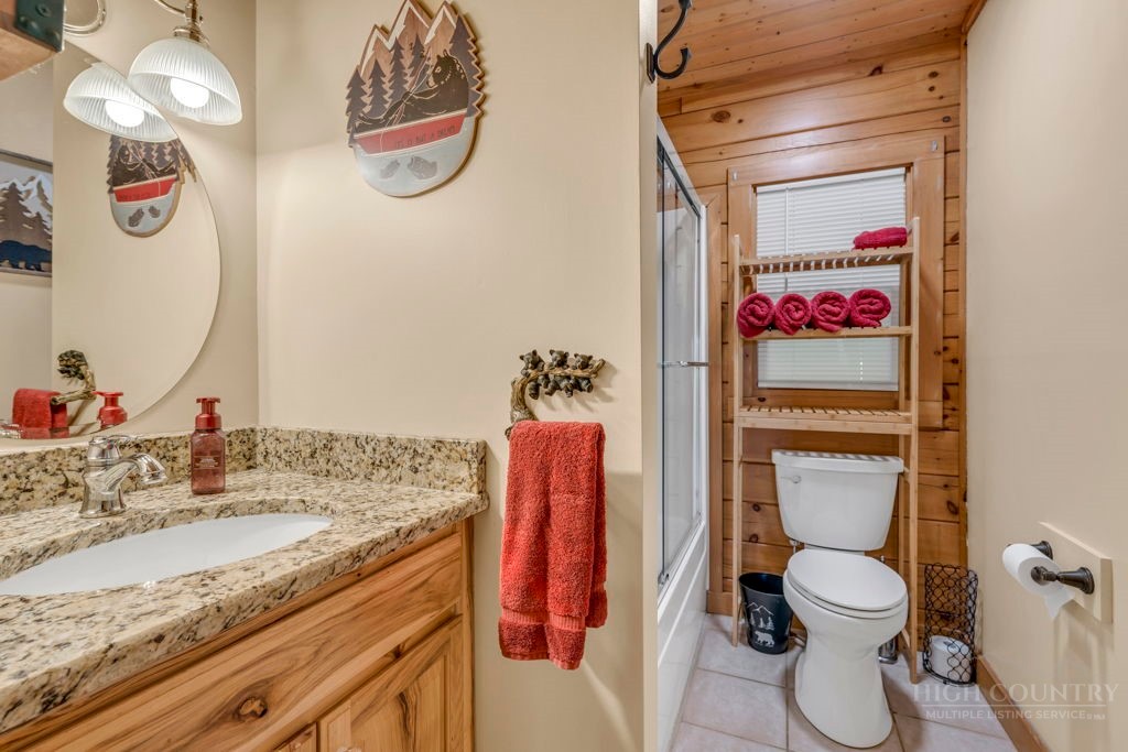 2229 Elk Ridge Road Ferguson, NC 28624 - Photo 24 of 42 a bathroom with a sink vanity mirror and toilet