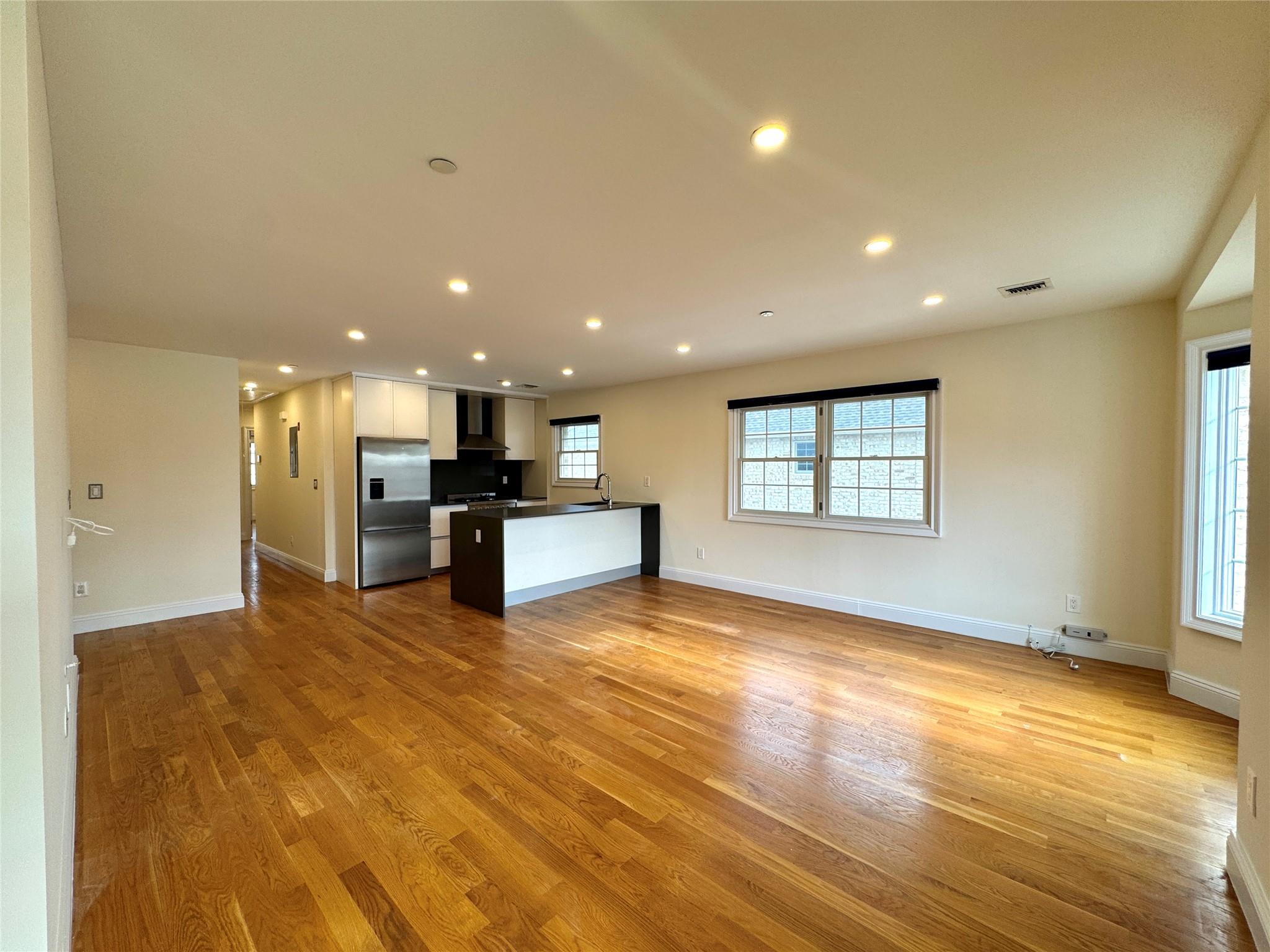 151-03 17th Avenue Queens, NY 11357 - Photo 1 of 1 Unfurnished living room with light wood-type flooring and sink