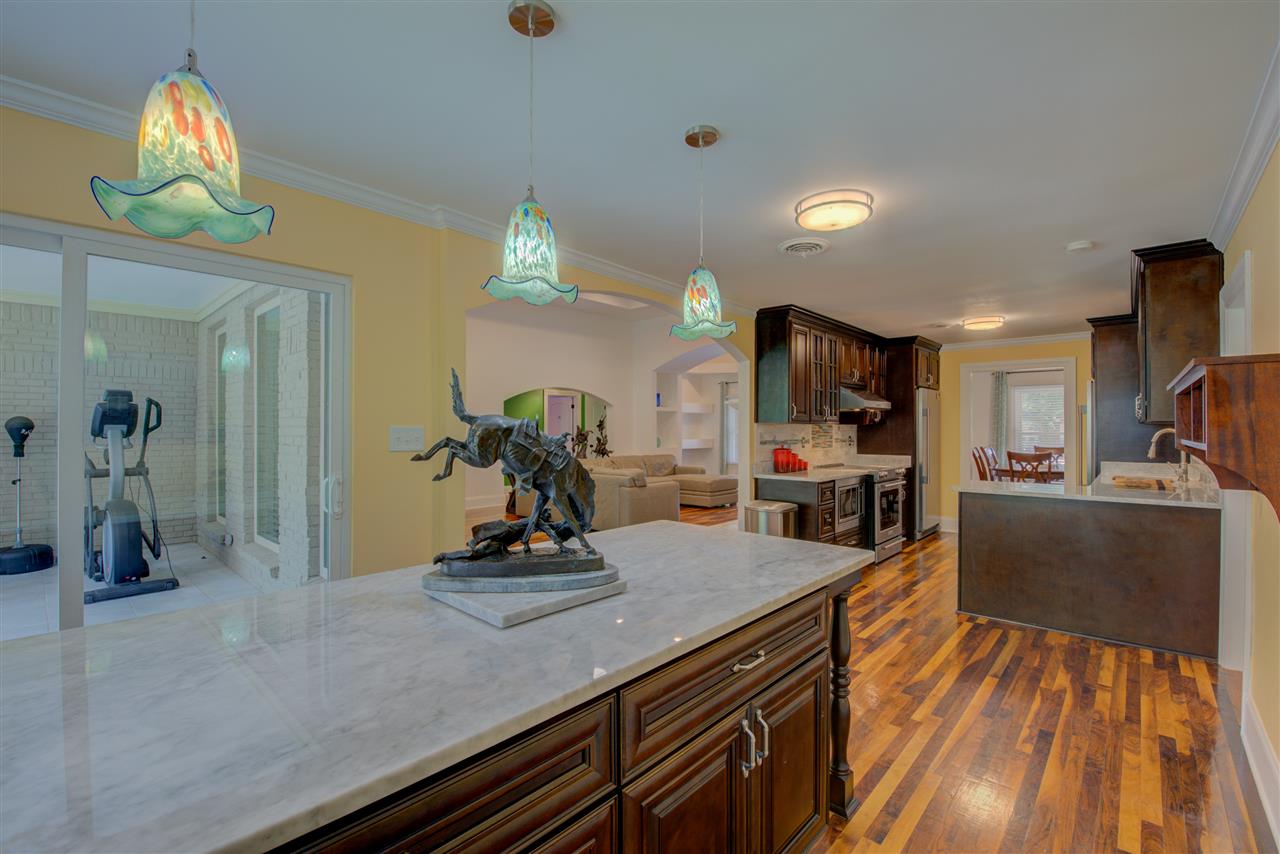 1915 Corbin Road Germantown, TN 38139 - Photo 12 of 25 With a breakfast area and bar, this stylish eat-in kitchen provides the perfect spots for quick snacks, on the go-dinners and sit down meals.