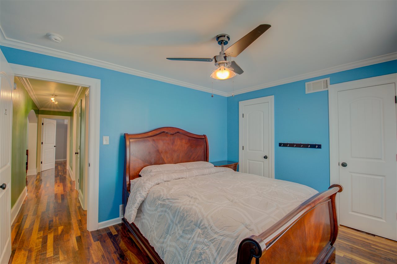 1915 Corbin Road Germantown, TN 38139 - Photo 19 of 25 Rest and recharge in the third bedroom featuring smooth ceilings, walnut hardwood flooring, double closets, cooling ceiling fan/light, and a shared full hall bathroom.