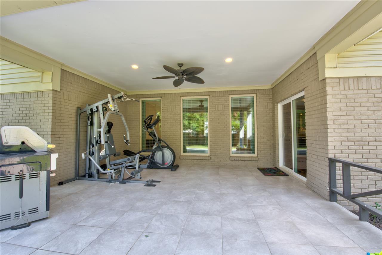 1915 Corbin Road Germantown, TN 38139 - Photo 21 of 25 Relax outside in the fenced backyard with a delightful covered, tiled patio with a cooling ceiling fan, perfect for cookouts and parties!