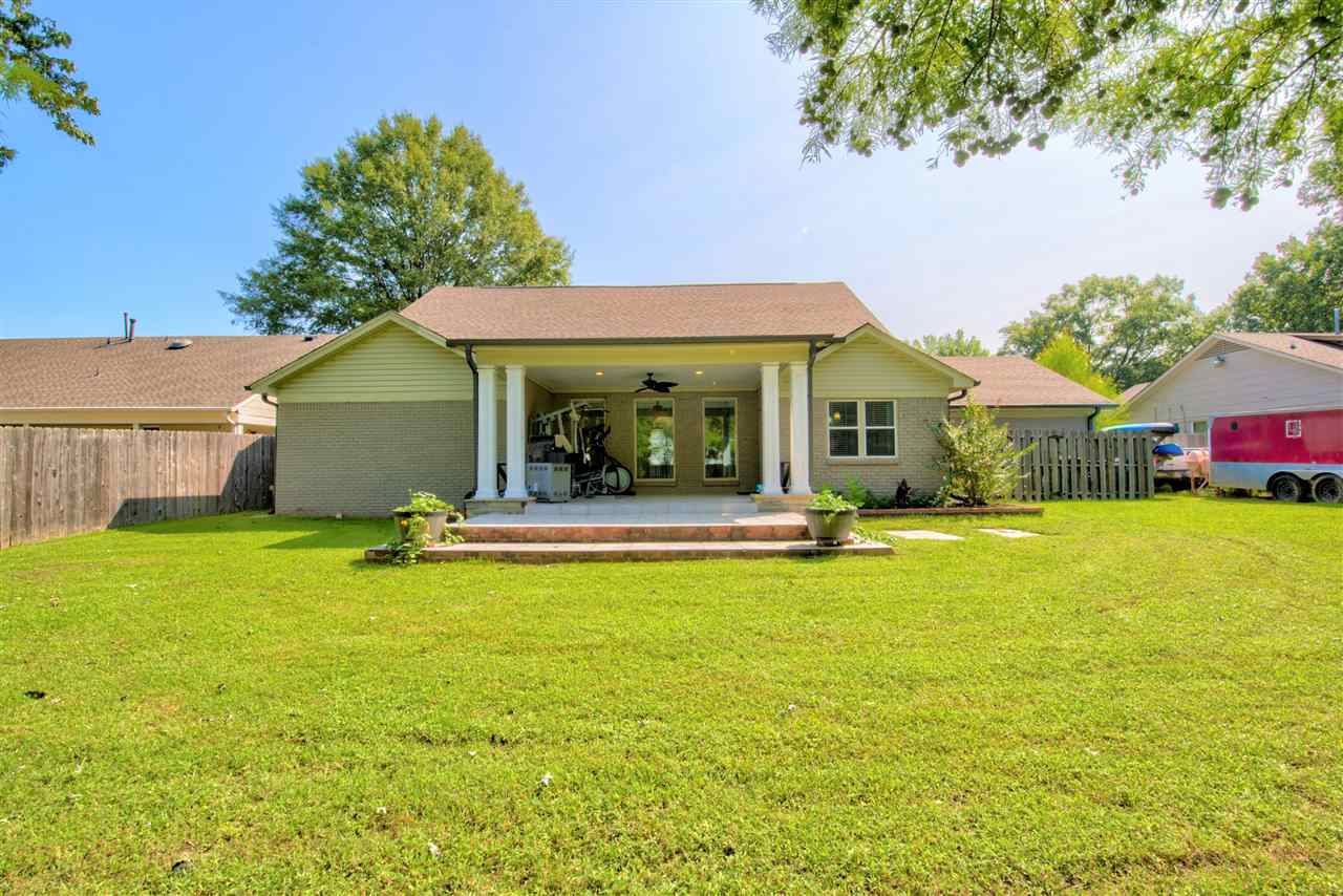 1915 Corbin Road Germantown, TN 38139 - Photo 23 of 25 Relax outside in the fenced backyard with a delightful covered, tiled patio with a cooling ceiling fan, perfect for cookouts and parties! This amazing home is in the Germantown Municipal School District (Farmington Elementary, Houston Middle and High).