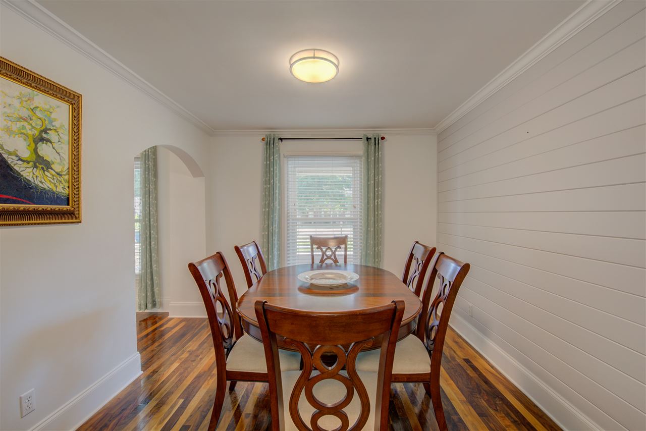 Host the finest dinner parties in the romantic dining room with gorgeous walnut hardwood floors, smooth ceiling, arched doorway, and crown molding.