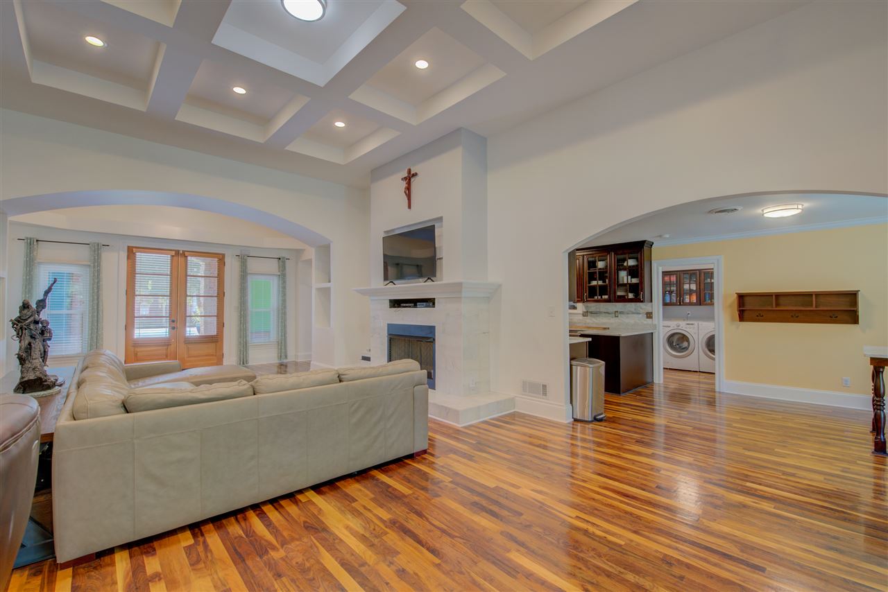 1915 Corbin Road Germantown, TN 38139 - Photo 8 of 25 Enjoy comfortable everyday living in the captivating great room flaunting beautiful walnut hardwood floors, soaring smooth tray ceiling, recessed lighting, arched doorways, neutral color palette, cozy fireplace, TV niche and built-in shelving.