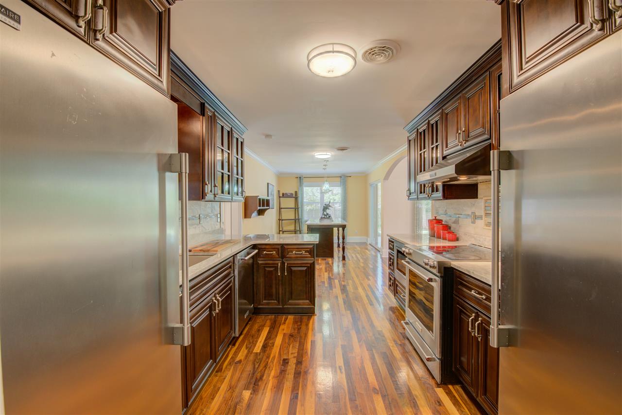 1915 Corbin Road Germantown, TN 38139 - Photo 9 of 25 Style and Utility are masterfully fused together in this gourmet kitchen with a full complement of stainless steel appliances including a self cleaning oven, cook-top, microwave, dishwasher, double sinks, refrigerator and freezer.