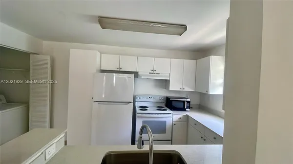 a kitchen with a refrigerator a stove a sink and a refrigerator