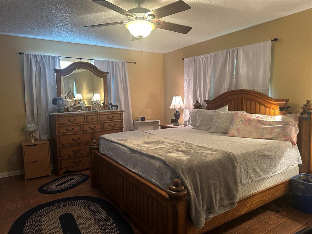 245 County Road 3696 Springtown, TX 76082 - Photo 12 of 29 a bedroom with a bed and a dresser