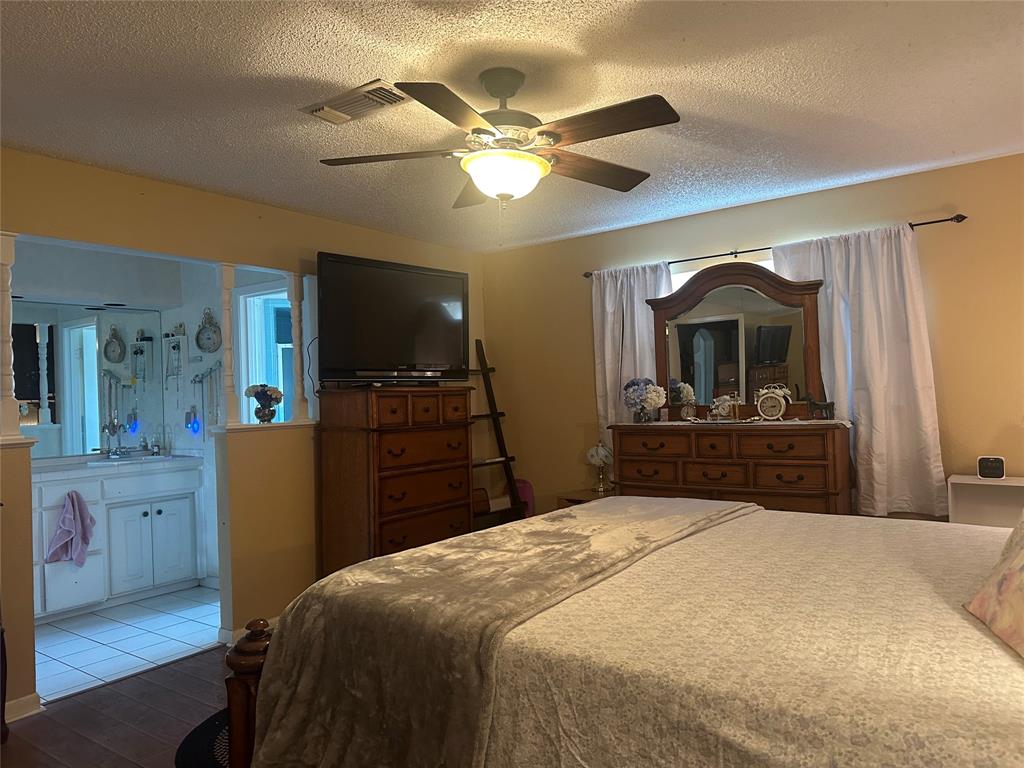 245 County Road 3696 Springtown, TX 76082 - Photo 13 of 29 a bedroom with a bed and a flat screen tv