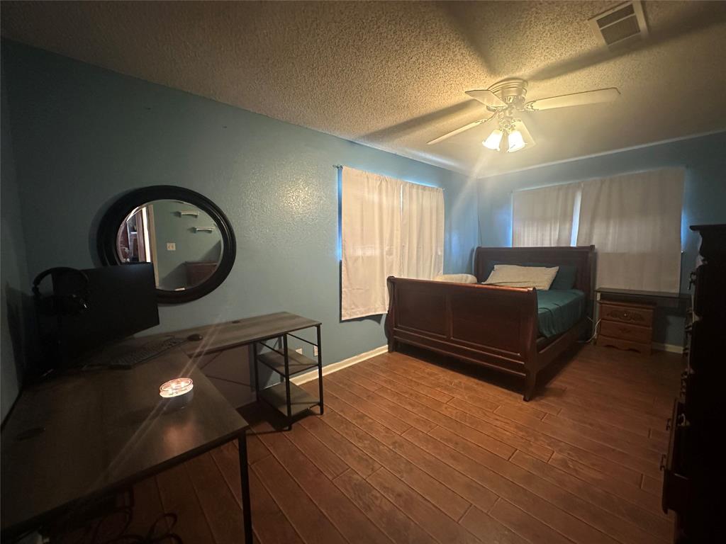245 County Road 3696 Springtown, TX 76082 - Photo 18 of 29 a living room with furniture a mirror and a ceiling fan