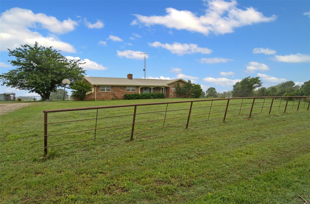 245 County Road 3696 Springtown, TX 76082 - Photo 2 of 29 a view of a golf course with a fence