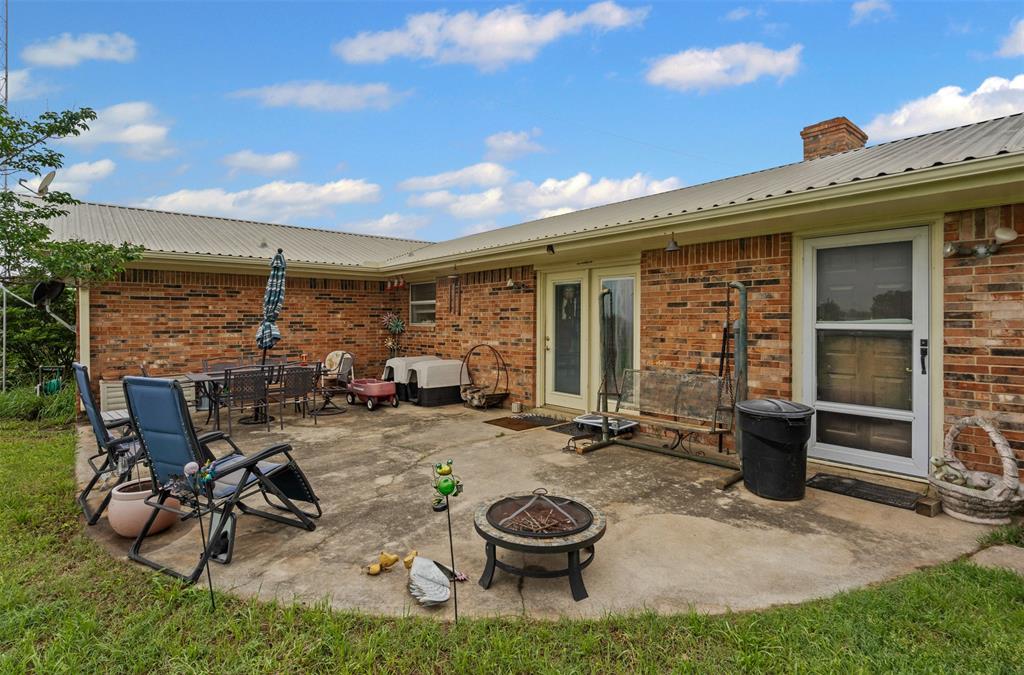 245 County Road 3696 Springtown, TX 76082 - Photo 21 of 29 a view of a chairs and table in backyard of the house