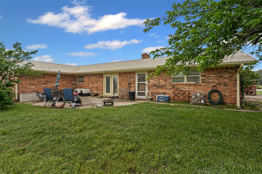 245 County Road 3696 Springtown, TX 76082 - Photo 22 of 29 a view of a couches in patio and a yard