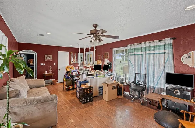 a living room with furniture a flat screen tv and a large window
