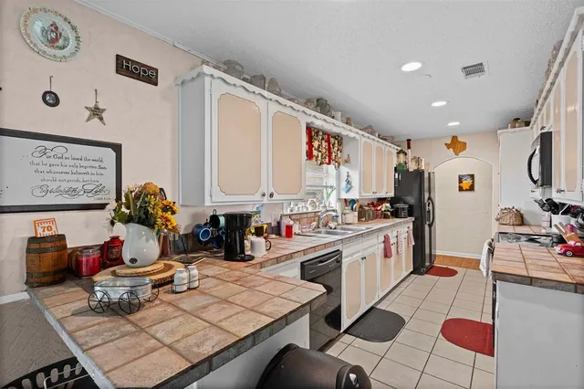 a kitchen with a sink and cabinets