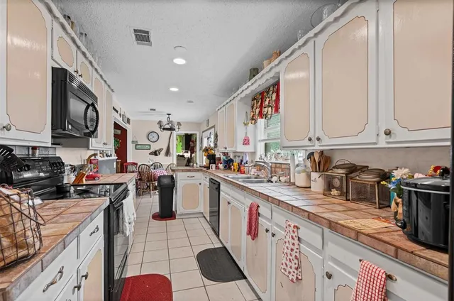 a kitchen with lots of counter top space and wooden floor