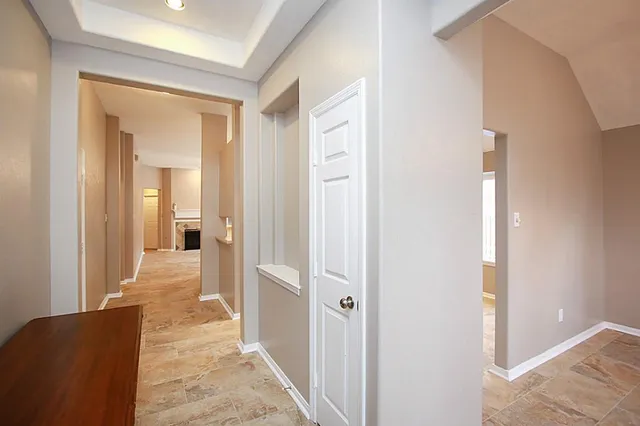a view of a hallway with a livingroom and a hallway