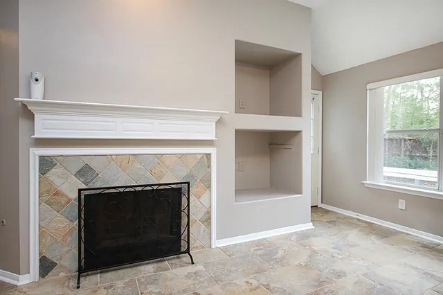 a living room with a fireplace and a table