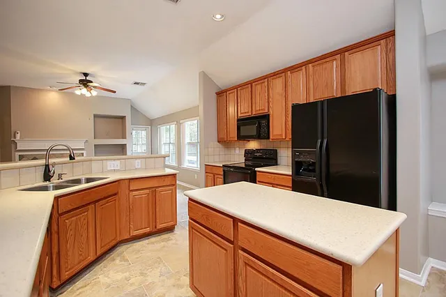 a kitchen with stainless steel appliances a sink cabinets and refrigerator
