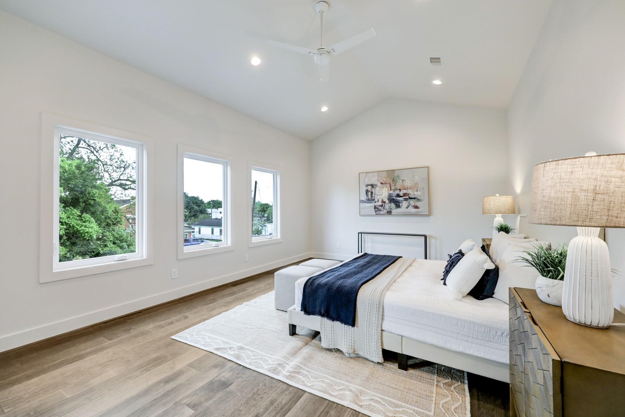 3827 Arlington Street Houston, TX 77018 - Photo 17 of 39 This spacious bedroom features high ceilings, three large windows providing ample natural light, and warm wood flooring.