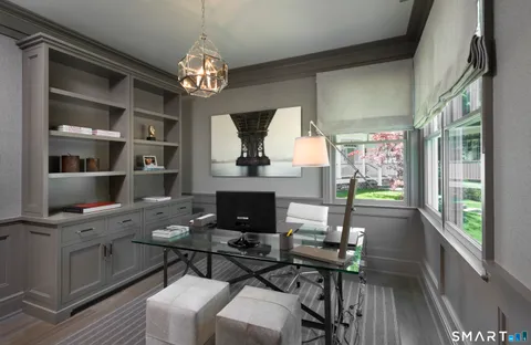 a view of a dining room with furniture a chandelier and wooden floor