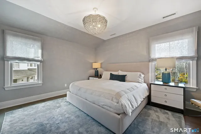 a bathroom with a granite countertop sink a toilet and shower