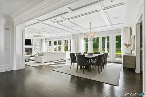 a kitchen with granite countertop a stove and a wooden floor