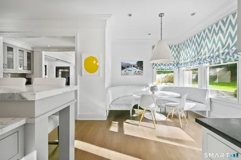 a large kitchen with cabinets a sink a counter space and stainless steel appliances