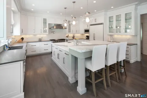 a kitchen with stainless steel appliances white cabinets and a sink