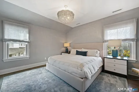 a bedroom with a large bed and a window