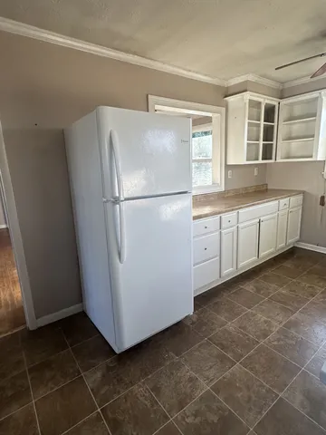 a white refrigerator freezer sitting inside of a kitchen