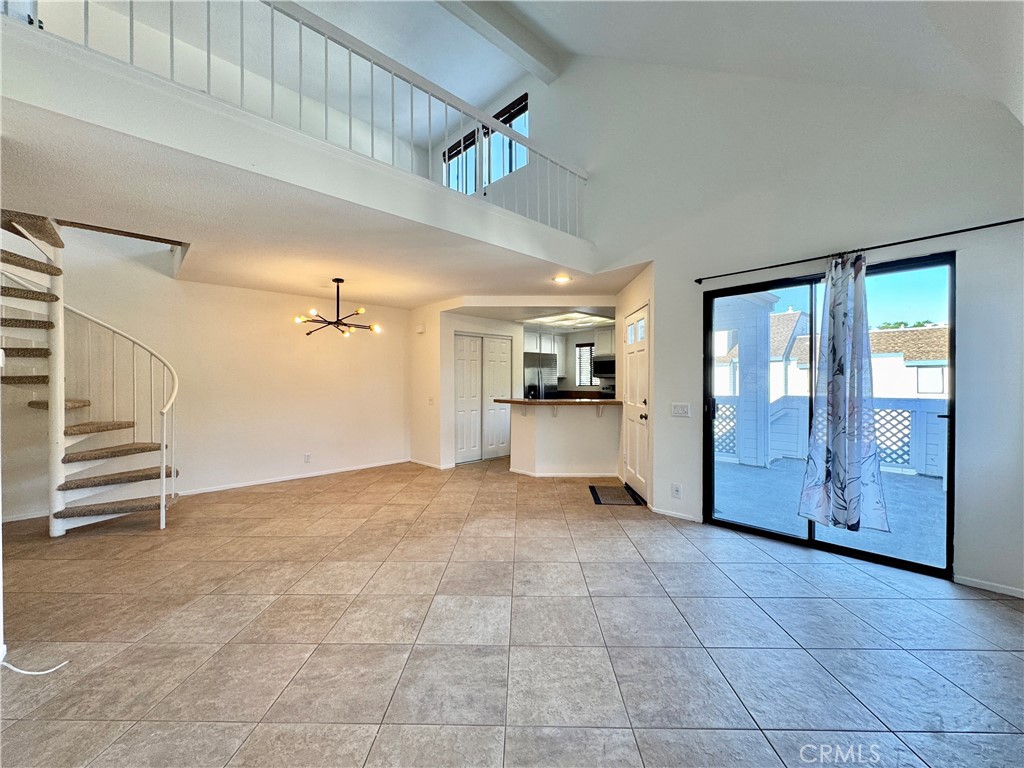 109 Fallingstar, Unit 61 Irvine, CA 92614 - Photo 11 of 34 a view of an empty room and a kitchen