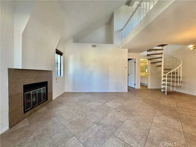 a view of an empty room with a fireplace